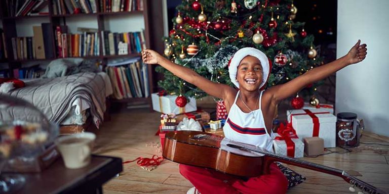 Little Boy Receives a Starter Guitar for Christmas